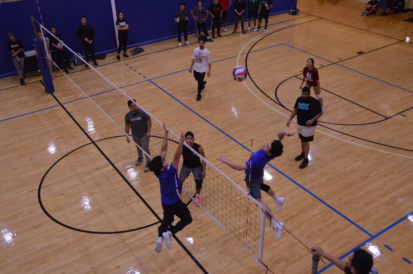 Students playing volleyball inside CRC.