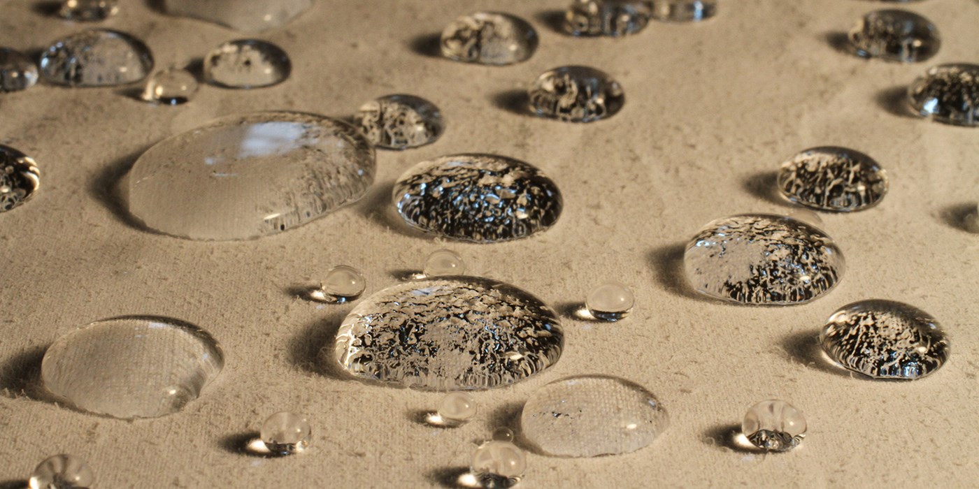 Closeup of water droplets on tan fabric